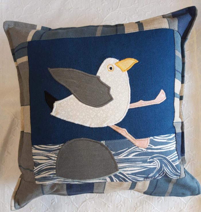 Seaside Seagull 'Oops' cushion. Linen and cotton ground with appliqué, blue and grey striped border and grey back.