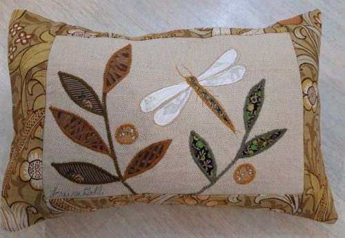 Dragonfly facing left cushion. Vintage Morris Golden Lily border, textured ochre back.