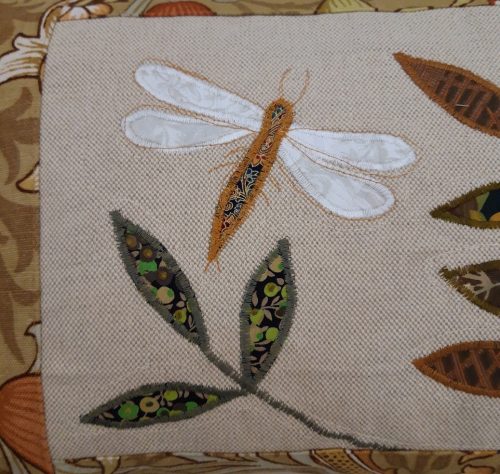 Dragonfly facing right cushion. Vintage Morris Golden Lily border, textured ochre back.