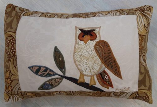 Owl on a branch facing left cushion. Vintage Morris Golden Lily border, smooth ochre back.