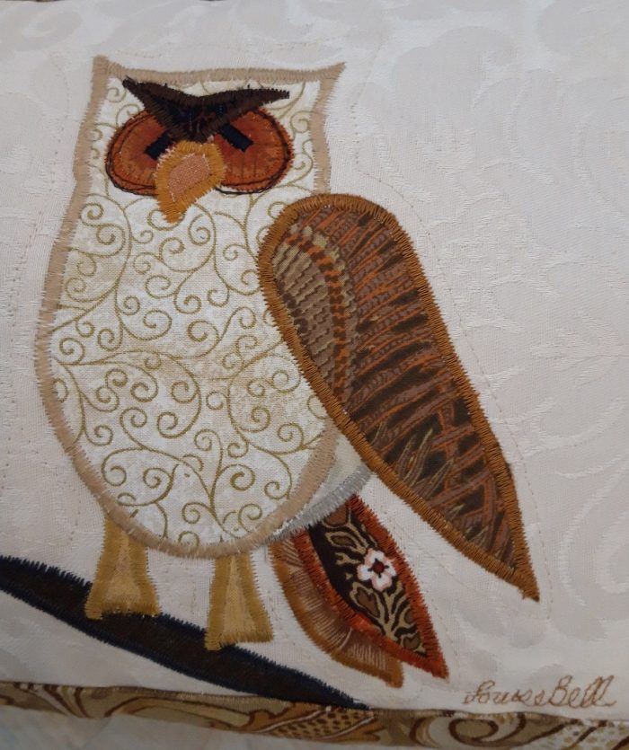 Owl on a branch facing left cushion. Vintage Morris Golden Lily border, smooth ochre back.