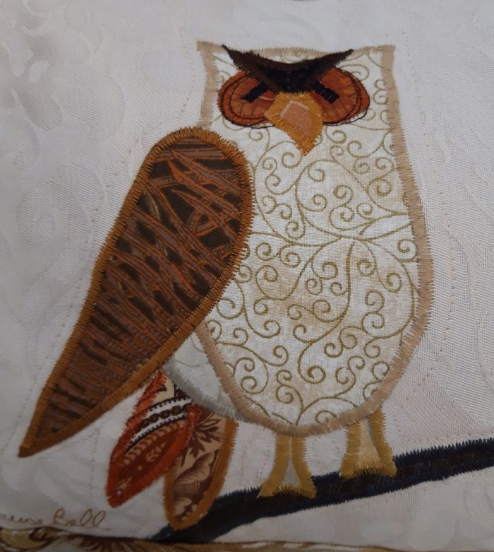 Owl on a branch facing right cushion. Vintage Morris Golden Lily border, smooth ochre back.