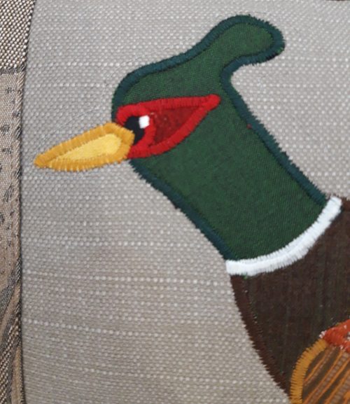 Pheasant running left cushion. Brown leaf fabric border, and back.
