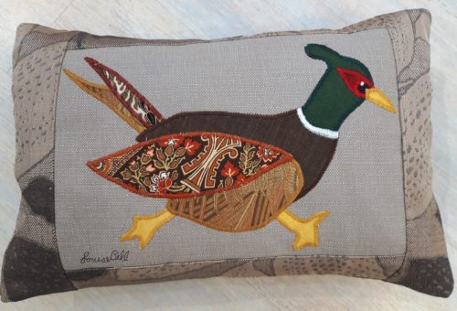 Pheasant running right cushion. Brown leaf fabric border, and back.