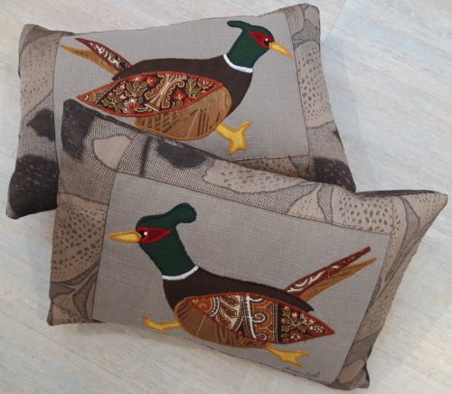 Pair of pheasant cushions. Brown leaf fabric border, and back.